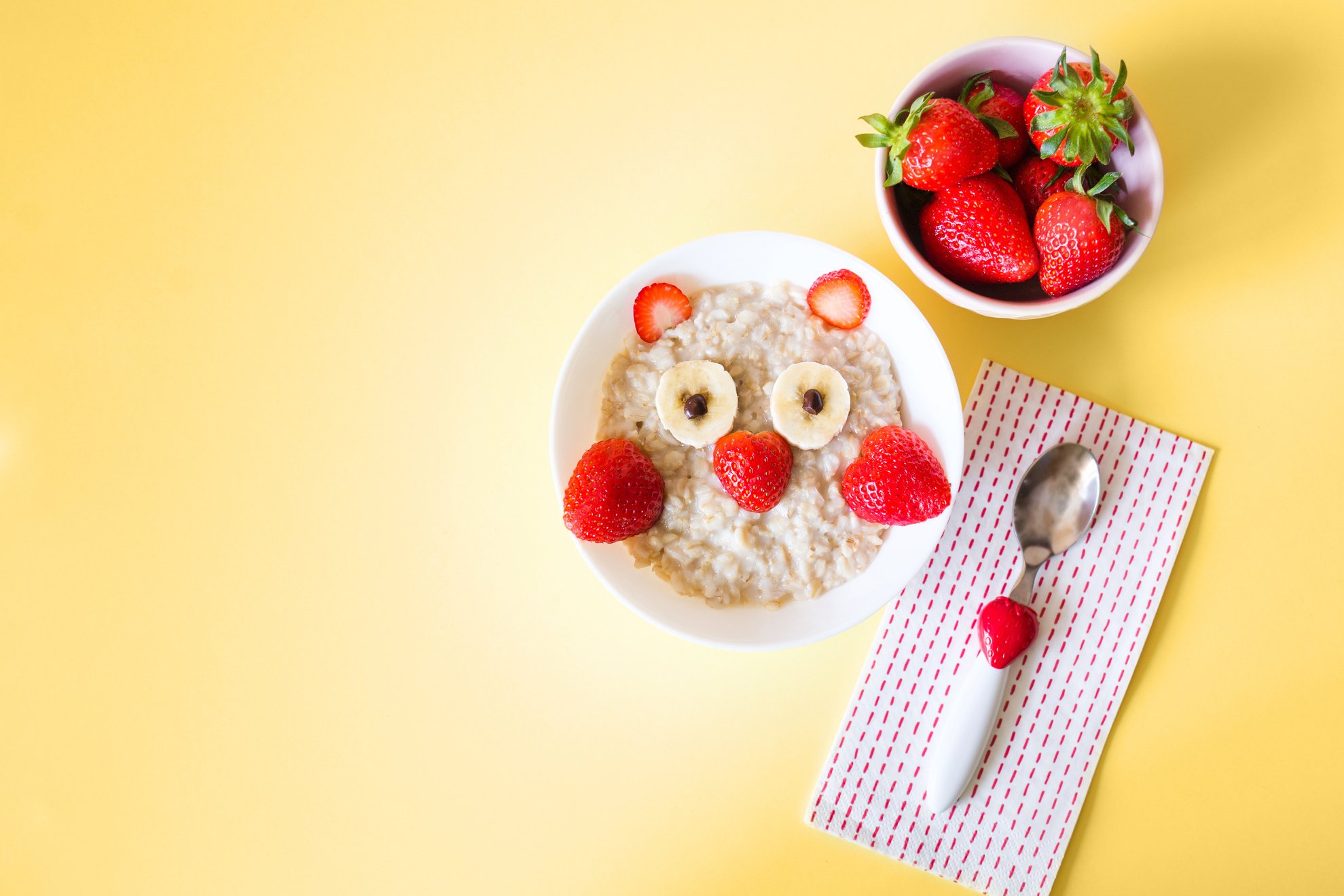 kid food. children's plate with oatmeal and strawberry owl. healthy breakfast